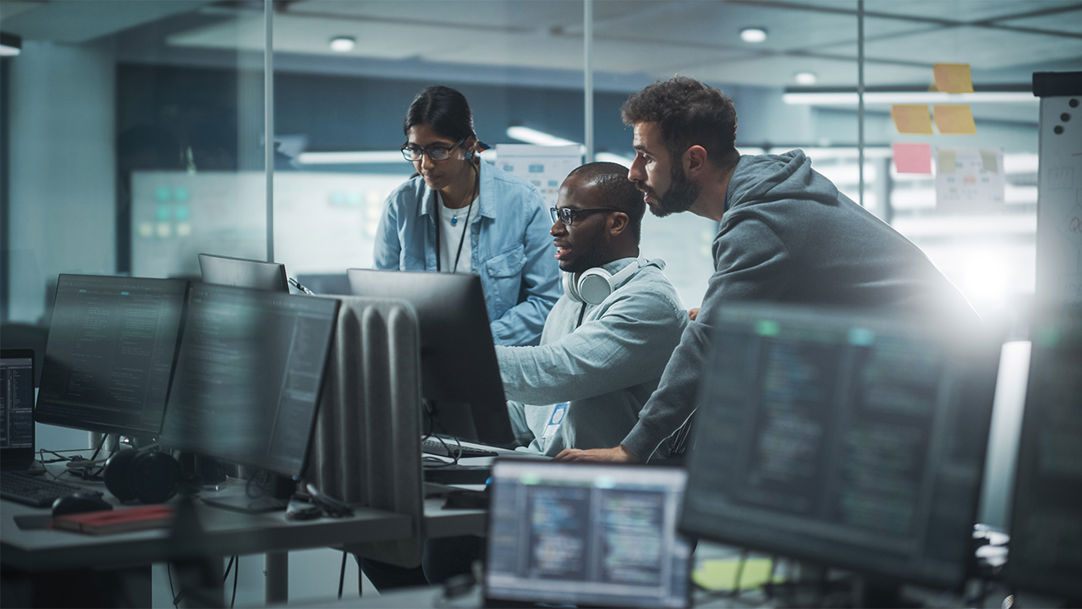cyber security experts gather around a workstation for an asset discovery exercise